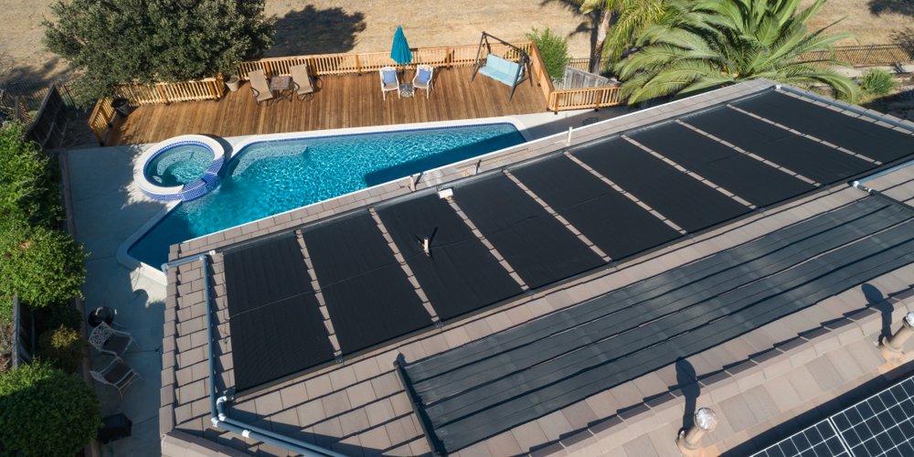 solar mats on a roof to heat water for a pool