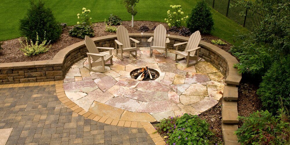 inground fire pit in a stone patio