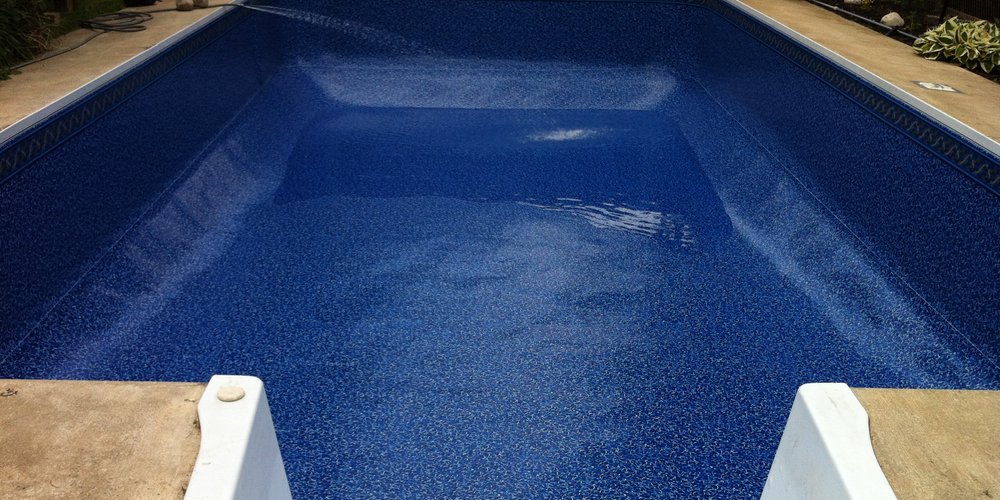 freshly installed dark blue pool liner