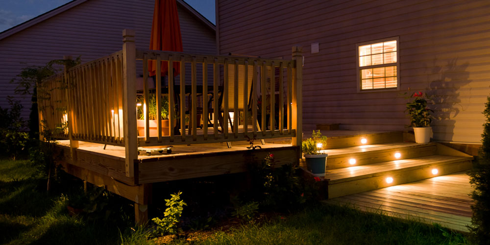 wooden deck with lights on the stairs