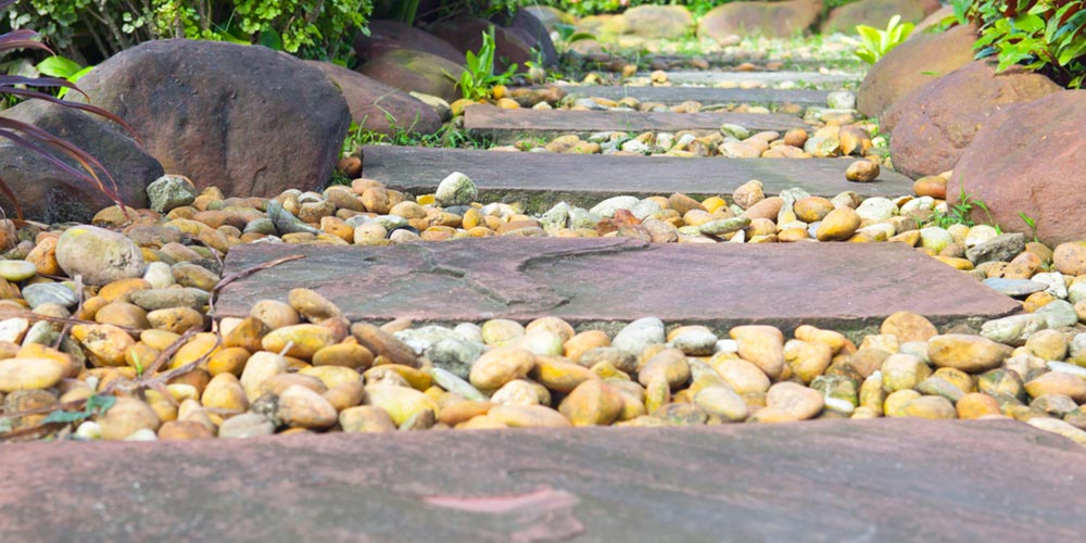 natural stone pathway with pebbles inbetween the pavers