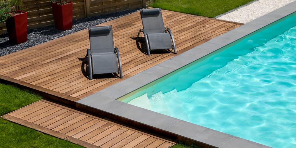 pool with deck terrace and sunbathing chair