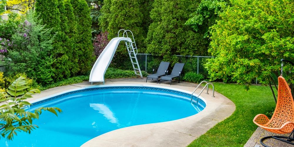 backyard pool with a slide