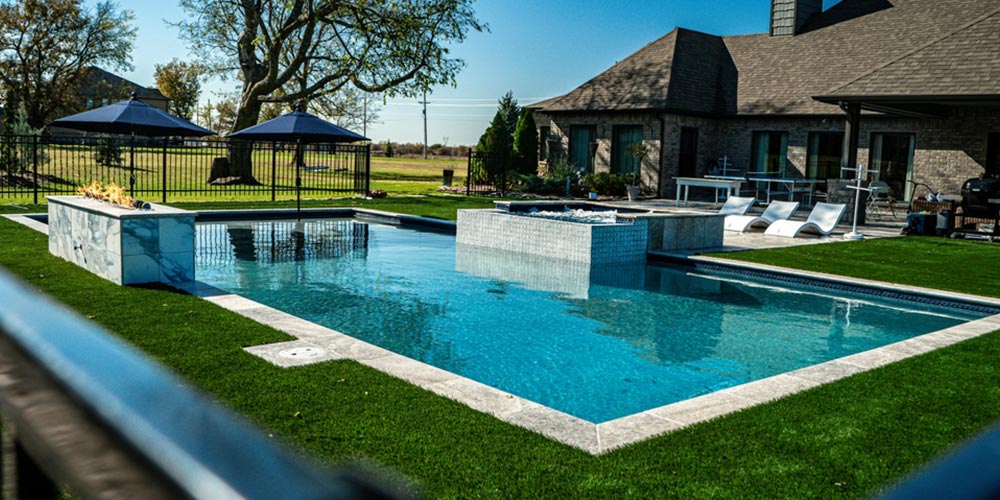 outdoor swimming pool with patio and jacuzzi
