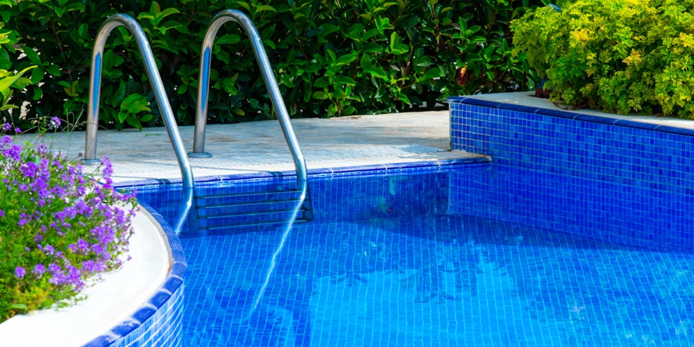 tiled swimming pool with ladder rails coming out