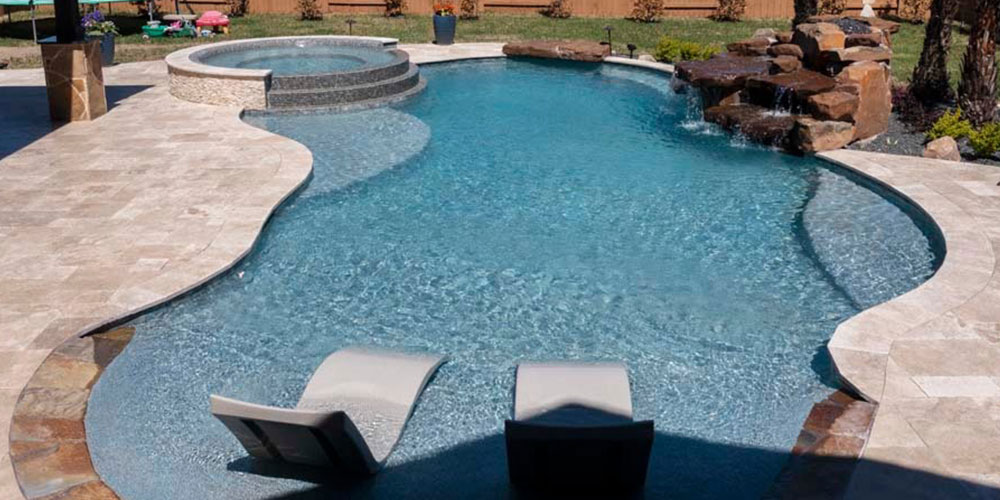backyard pool with spa, tanning ledges, waterfall and in pool furniture