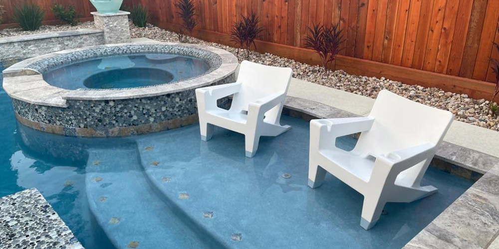 resin pool chairs on a pool ledge