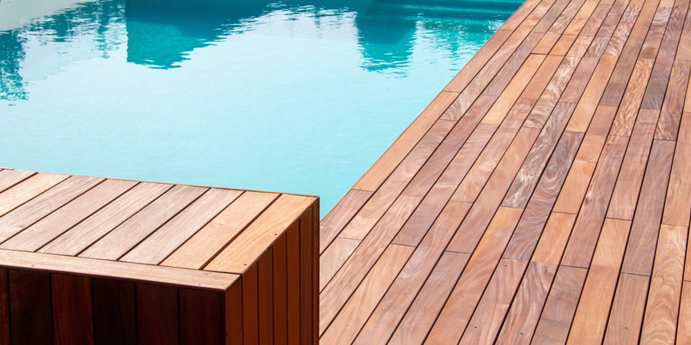 hardwood deck surrounding a pool