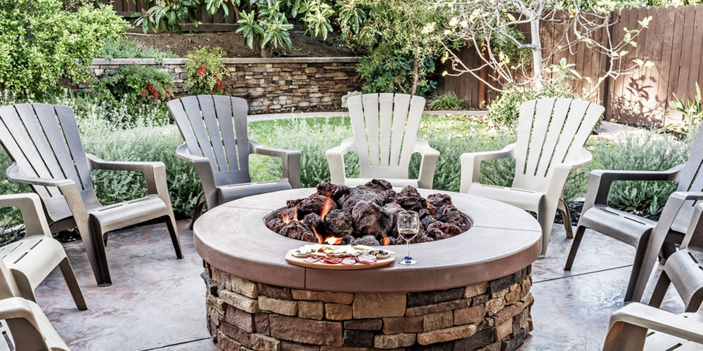 outdoor fire pit surrounded by wooden rocking chairs