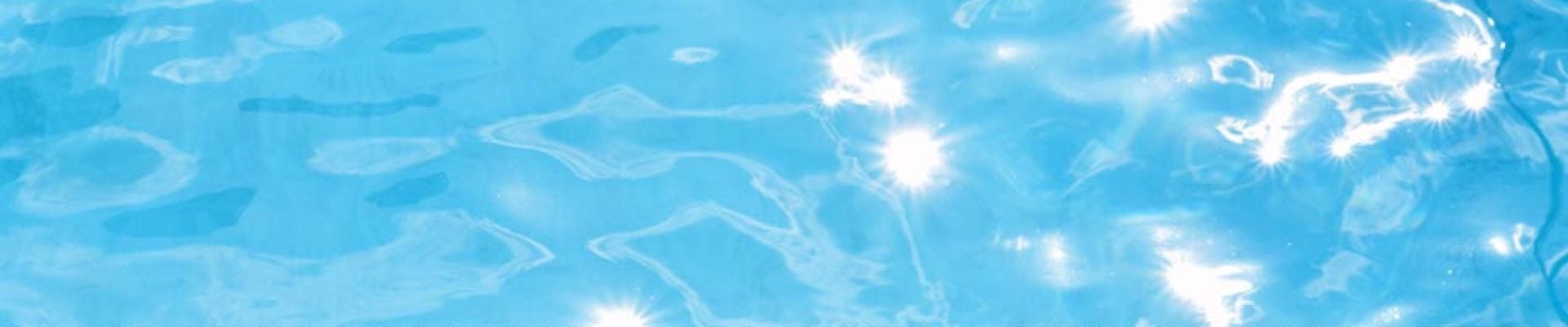A swimming pool with the words "DEEP END" written on the edge, reflecting sunlight on the water's surface.