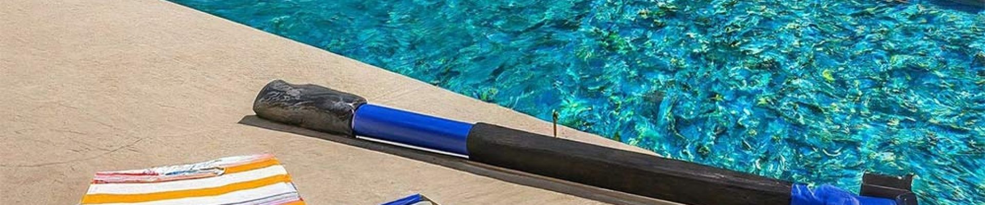 professional pool cleaning kit next to pool