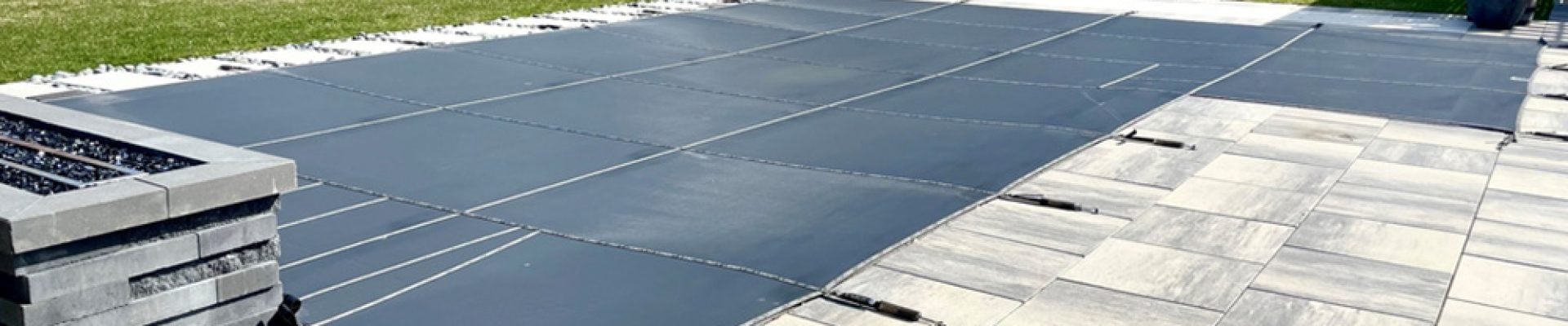 winterized inground pool with mesh cover