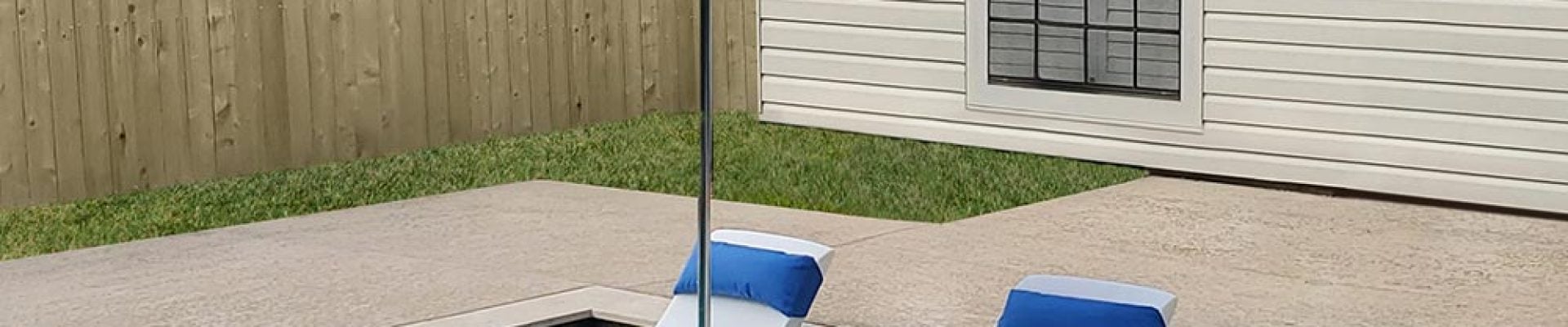 A pool with chairs and umbrella.